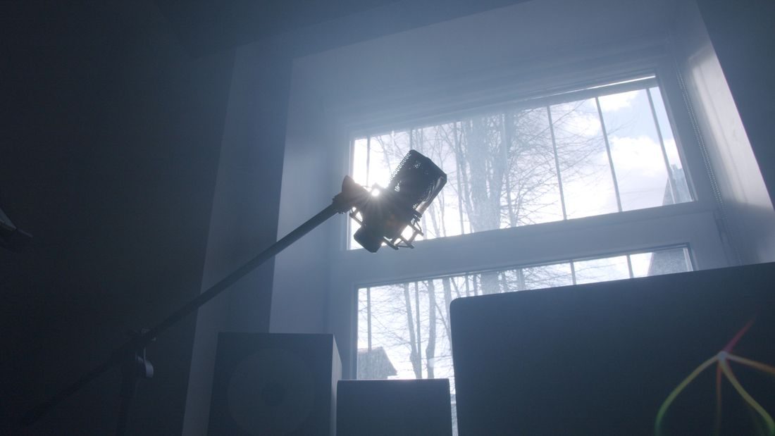 A microphone stand in a quiet sunlit room.