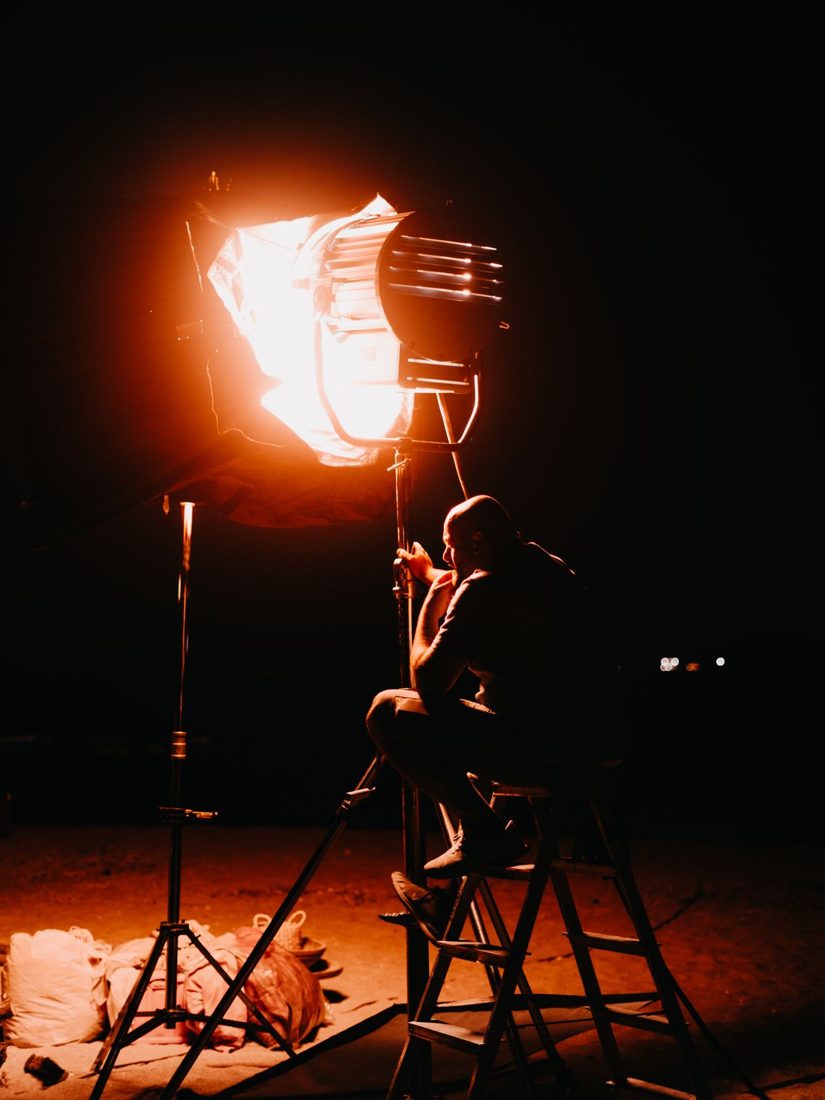 A studio spotlight against a dark background.