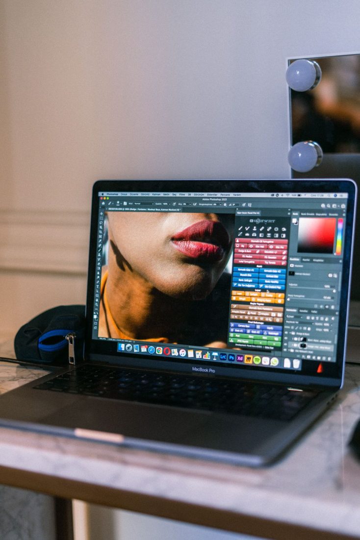 A laptop displaying graphic editing software.